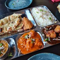 Thali with dal, ghobi manchurian, butter unchicken, rice, samosa and chilli garlic naan at Veggiesaurus in The Hague