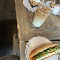 Began breakfast with iced oat latte, blueberry cake and sandwich  at Espresso House in Mora