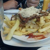 Vegan chorrillana - with seitan, scrambled tofu, caramelised onions and loads of chips. 

Note the pisco sour on the side :) at Soju in Santiago