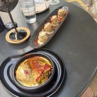 Stuffed peppers with hollandaise sauce and croquetas in the backgroundd  at Bubita Bar in Barcelona