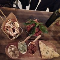 Fried calamari, mini tomato salad with basil leaves and dips. at Bubita Bar in Barcelona