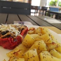 Red bell pepper filled with rice and potatoes on the side at Veganda in Padua
