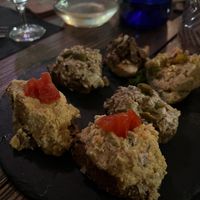 The two crostini in front featured bland hummus, the one in the far left corner with the seitan was good, the rest tasted like straight mayonnaise    at Veganda in Padua