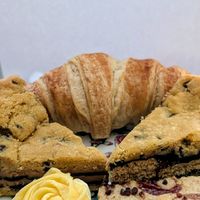Our take-home treats, croissant, biscoff cookie pie, twyx cookie pie, raspberry ripple blondie, veganese whirl at Harbours Vegan Bakery in Lancing