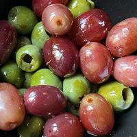 Marinated Castelvetrano olives & red grapes  at Charlie Was a Sinner in Philadelphia