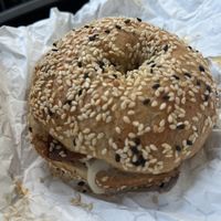 sesame bagel with vegan bacon, butter and onions  at Julio's Bagels in Richmond