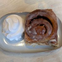 Cinnamon roll with cream at Considerit in Edinburgh