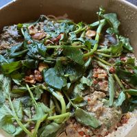 Rice Noodle w/almond hazelnut sauce, charred chili, greens. Very unique and yummy  at Harvest Community Foods in Vancouver