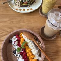 Avo mushroom toast, cacao smoothie bowl, passion mango smoothie and a Vietnamese iced coffee  at 2 Roots Plant-Based Café in Ho Chi Minh City