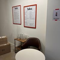 Cardápio e quadro explicando a missão de causar impacto positivo por meio do prazer do café at Bakea in Paris