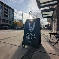 Sidewalk sign with logo at Coffee Villain in North Vancouver