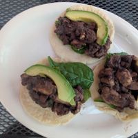 Order these sides to make tacos! Black beans, avocado, corn tortillas, uncooked spinach & mushroom. Cut up the mushrooms & mix them into the hot beans to soften & soak up flavor! at Food Bash in Winchester