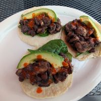 Order these sides to make tacos! Black beans, avocado, corn tortillas, uncooked spinach & mushroom. Cut up the mushrooms & mix them into the hot beans to soften & soak up flavor! at Food Bash in Winchester