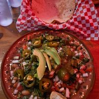 Handmade tortillas under pintos Salsa Fresca and avocado. I love it. at Mas Amor in Chico