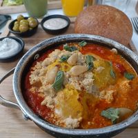 Hot Shakshuka plate with Fettah cheese on top at Anastasia in Tel Aviv