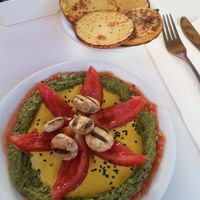 Starter with Humusomlette and grilled mushrooms, Tomato, Pesto and a delicious variaty of Tahini at Anastasia in Tel Aviv