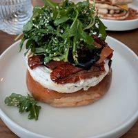 Bun with dill cream cheese, sundried tomatoes  bacon and balsamic reduction at BIG Sister in London