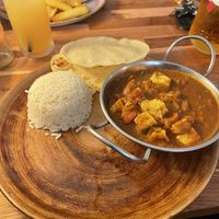 tofu tikka, rice and naan with a popadom and vegan burger in the background   at The Golden Fleece in Porthmadog