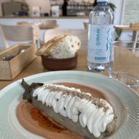 roasted eggplant, gojju cream (tomato and spices), mint and coriander chutney, vegan sauce, sesame seeds  at June Collective in Lombardia