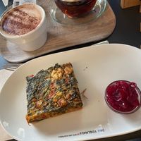 Quiche with spinach and vegan feta, onion chutney and mocchaccino with oat milk  at Das Voglhaus in Konstanz