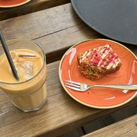 Oat milk iced latte and raspberry and coconut flapjack.   at Chestnuts Coffee in Norwich