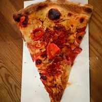 A slice of vegan pizza at Hatool HaYarok - The Green Cat at Hatool HaYarok - The Green Cat in Tel Aviv