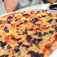 Cashew cheese pizza with pineapples and olives at Hatool HaYarok - The Green Cat in Tel Aviv