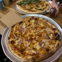 Pizza vegan pineapple and red onion and a large pizza with herbs, vegan salami and mushrooms  at Hatool HaYarok - The Green Cat in Tel Aviv