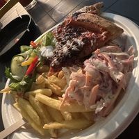 Pizza, salad, chips and coleslaw   at Slice Guys at Yellow Arch Studios in England