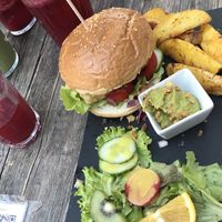 Crispy tofu burger with potato wedges and avocado dip at Moehren Milieu Eco Cafe in Mainz