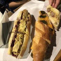 A sinistra baguette con würstel artigianale di impasto di ceci, senape e cipolla caramellata. A destra baguette con zucca, foglie di cappero, ceci e olive.   at Bi e B - Birre e Baguettes in Campania