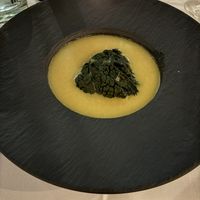 Creamy broth with a cavalo nero package filled with marinated jackfruit   at Waber. in Overijssel