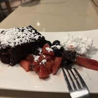 Vegan chocolate cake with mixed berries and coconut whipped cream   at Bravo in Jackson