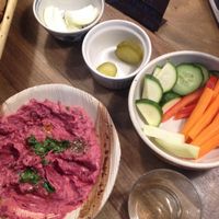 Beetroot hummus with bread and fresh vegetables. at Hummus Amamamusi in Krakow