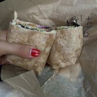 Veggie hummus wrap with pickled carrots added   at Purple Tomato Farmers Market in Lincoln