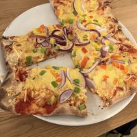 Vegan pizza with vegan cheese, onions and peppers  at Lalandia buffet in Billund