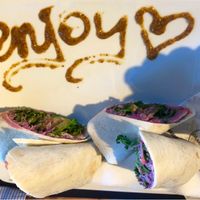 Hummus wrap with a cute enjoy message!  at Blueorange Coffee and Bagel - Margaretenstrasse in Vienna