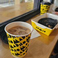 Iced Coffee with oat milk and Mushroom Aubergine Sandwich on the right.
Served in black charcoal bread, roasted portobello, vegan mayo and eggplant spread. at Nomad Bread & Coffee in Lefkosia
