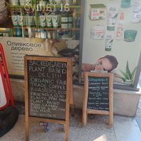 Sign at the street, the deli is in this alleyway at Sacred Garden Plant Based Deli in Rhodes
