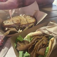 pastrami sandwich with sourdough bread and gyros pita  at Sacred Garden Plant Based Deli in Rhodes