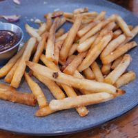 Stale, overcooked, store-bought (frozen, then cooked) french fries, served as "beer-battered fries". They were gross! at True North in Coburg