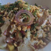 Chaat Masala Salad: crunchy veg, tomatoes, coriander, crispy rice and vegan yoghurt at The Slade Cafe in London