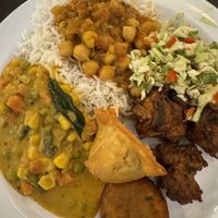 Buffet selections-chickpea masala, spicy salad, veg curry, pakoras and samosas.  at Radhe Pure Veg & Vegan in Oklahoma City