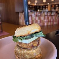fried tofu patty, mash brown, calabrian chili aioli, kale, and beer cheese on an english muffin  at Adelleda in Portland