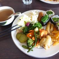 Miso soup and plate of various vegan tastes (wakame, wakame sushi, avocado sushi, vegetables, fried banana, fries, spring rolls, salads) at Sakura Sushi in Uusimaa