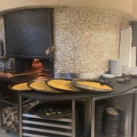 Forno a legna - teglie di farinata  at Dessì in Turin