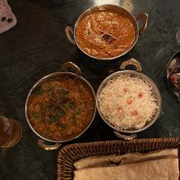 Vegan lamb curry (left), vegan butter chicken (top), rice, vegan cheese naan (bottom)  at OMNOM Birmingham in Birmingham
