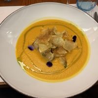 Pumpkin soup with marinated tofu and crispy potato chips  at MADREPERLA Bistrot in Friuli-venezia Giulia