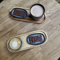 Cappuccino and maca with a piece of selfmade chocolate  at As Good As It Gets in Tilburg