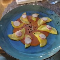 Ravioli RAW di zucchine ripieni di crema di mandorle e radicchio in salsa di datterino di Siracusa at Moon in Siracusa